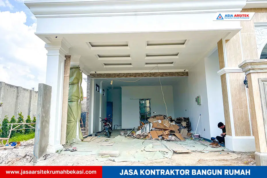 Area carport rumah tropis modern 2 lantai dengan atap dak beton dan akses langsung ke pintu utama